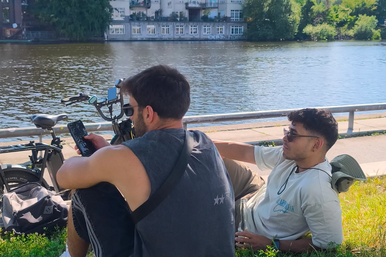 Two housemates sitting by the canal near home